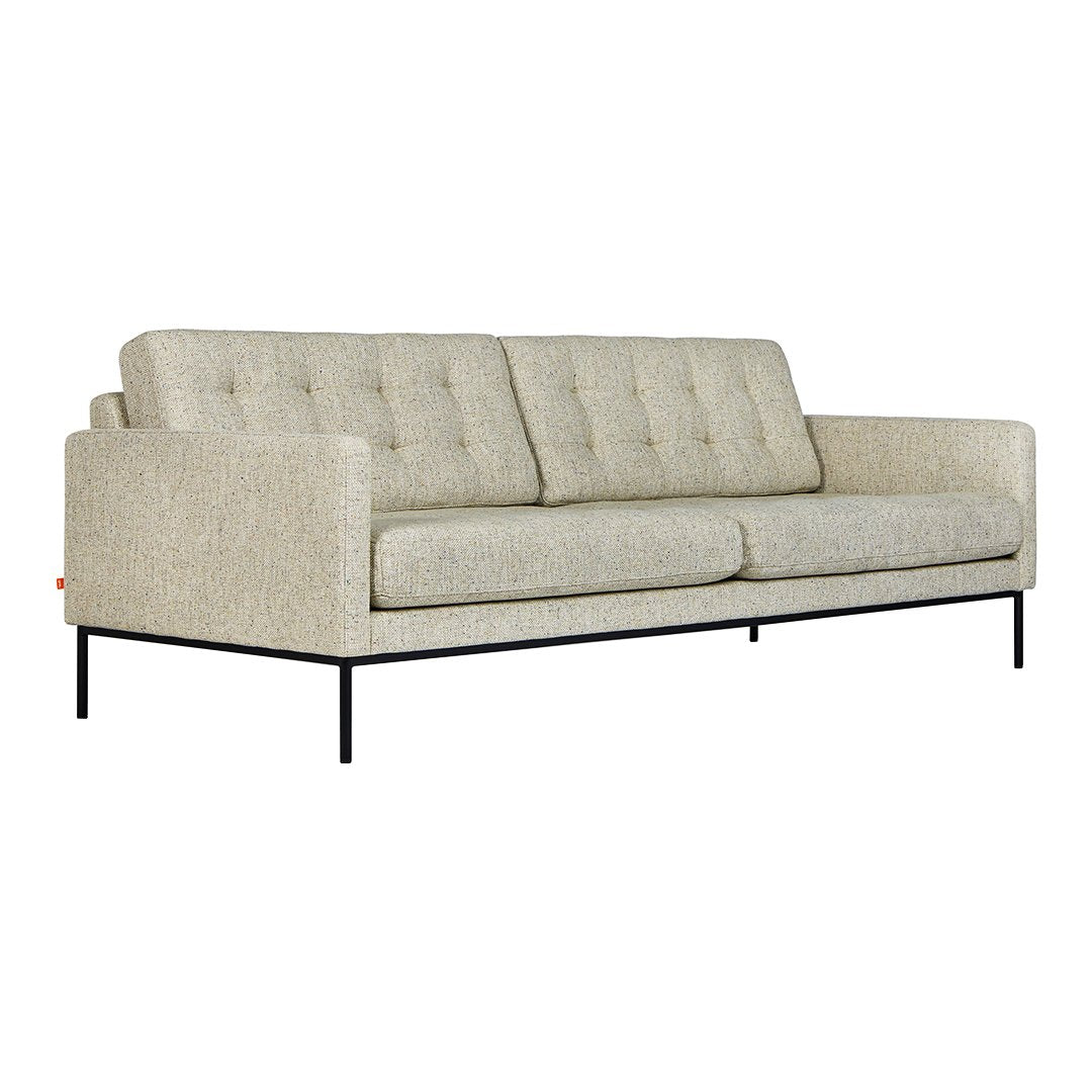 Light beige tufted sofa with a textured fabric and black metal legs, perfect for modern decor.