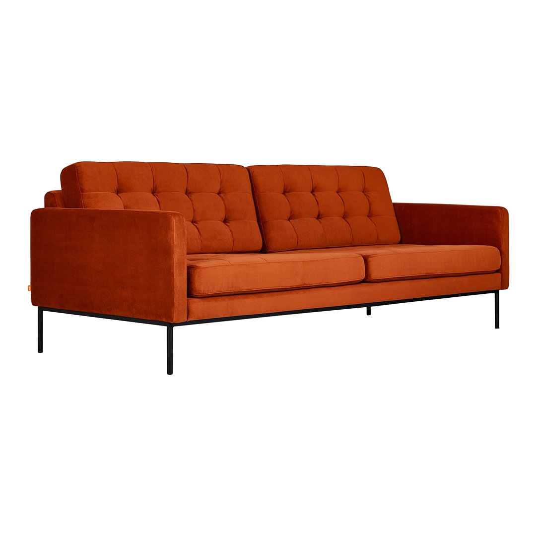Burnt orange velvet sofa with tufted design and sleek black metal legs. Ideal for modern living spaces.