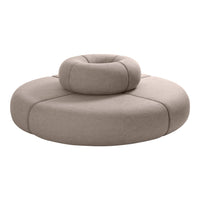 Round beige cushion with smooth texture and subtle seams, featuring a raised circular accent in the center.