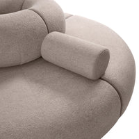 Soft beige curved sofa with rounded arms and a seamless, textured upholstery for a modern look.