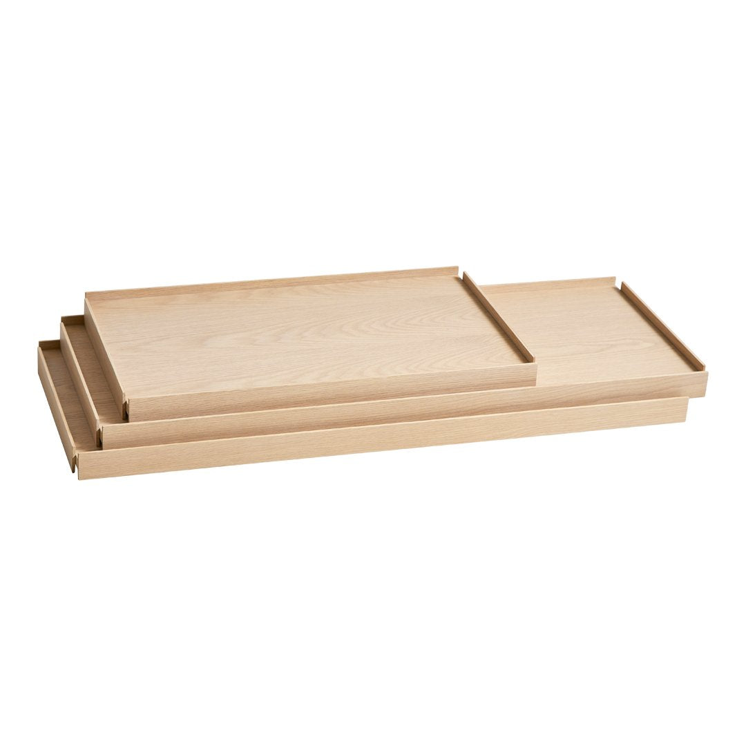 Set of three natural wood serving trays in light beige with smooth, minimalist design and no visible patterns.