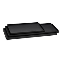 Set of three sleek, modern black trays stacked together, featuring a smooth, matte finish. Perfect for stylish organization.