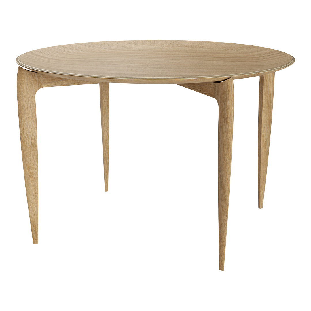Round wooden table in light blonde finish with smooth surface and minimalist design, featuring tapered legs.