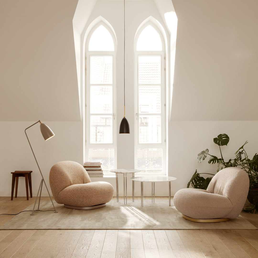 Light beige chairs with round shapes, subtle textures, and soft upholstered fabric in a bright, airy space.