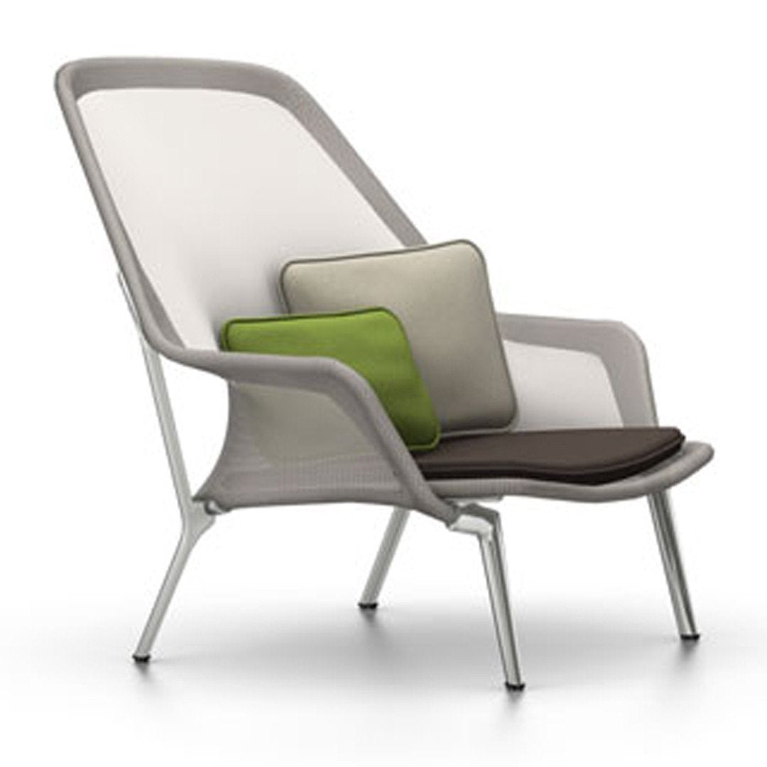 Modern chair in white and gray with green and beige cushions; stylish and contemporary design.