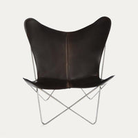 Brown leather butterfly chair with a minimalist design and sleek silver frame. Perfect for modern decor.