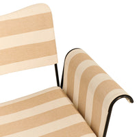 Beige and cream striped fabric on a modern chair, featuring sleek black metal arms for added contrast.