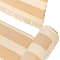Beige and cream striped throw with fringed edges, showcasing a subtle pattern for a cozy, modern aesthetic.