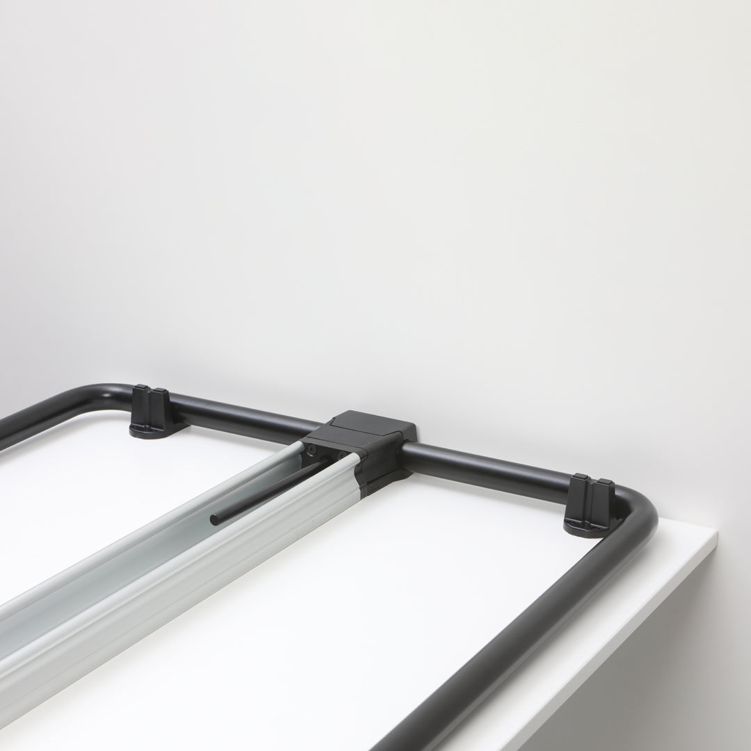 Black and silver folding table frame against a white background. Modern design with sleek lines and minimalistic style.