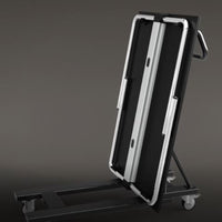 Folding cart with a sleek black surface and silver metallic accents, designed for easy mobility.