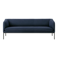 Navy blue modern sofa with a minimalistic design and sleek black metal legs. 