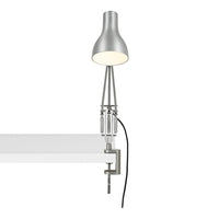 Silver metallic lamp with a sleek, modern design, featuring a minimalist clamp and a light grey cord.