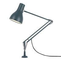 Dark teal metal lamp with a sleek design and a matte finish, featuring a contrasting light interior.