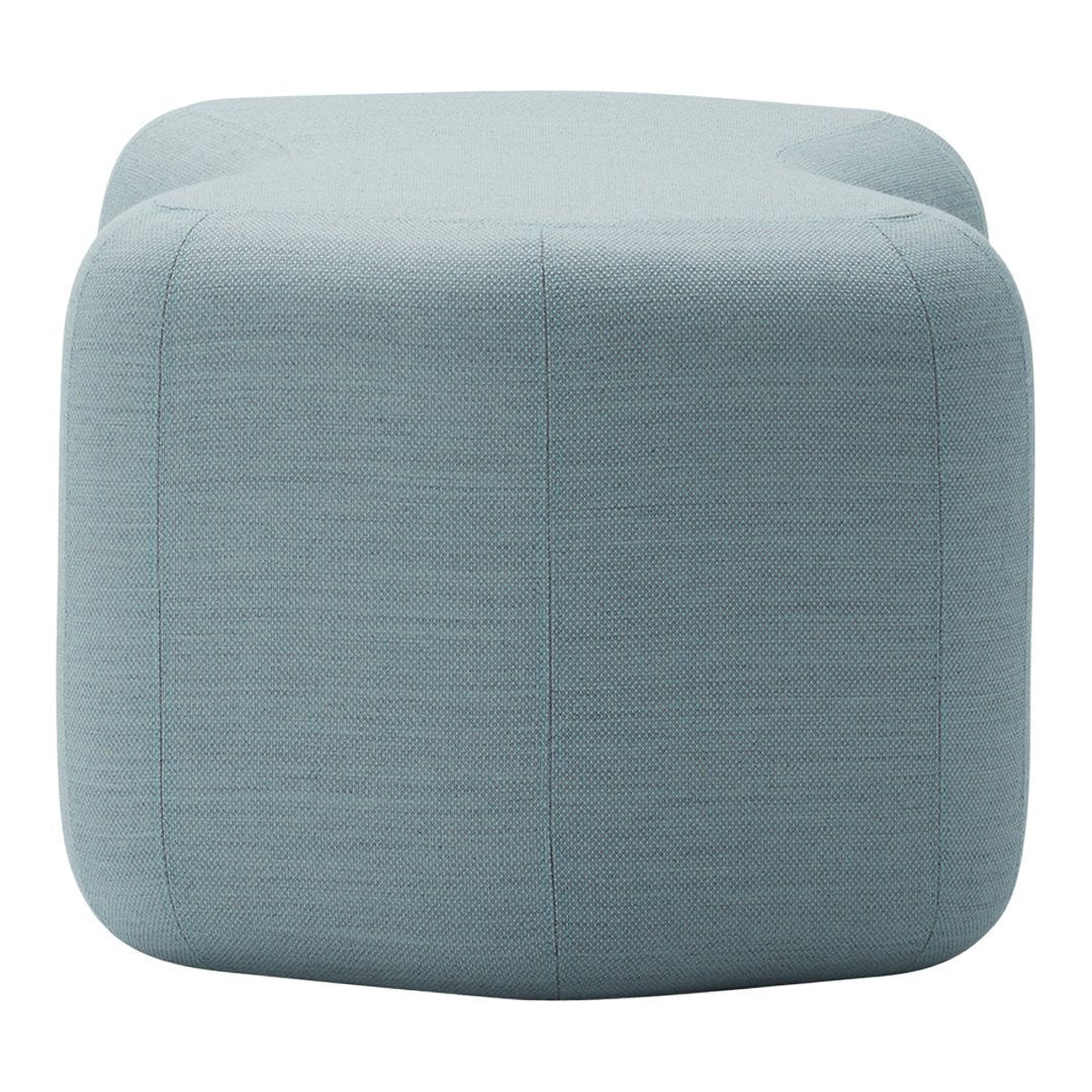 Light blue tufted ottoman with a textured fabric pattern, perfect for modern decor.