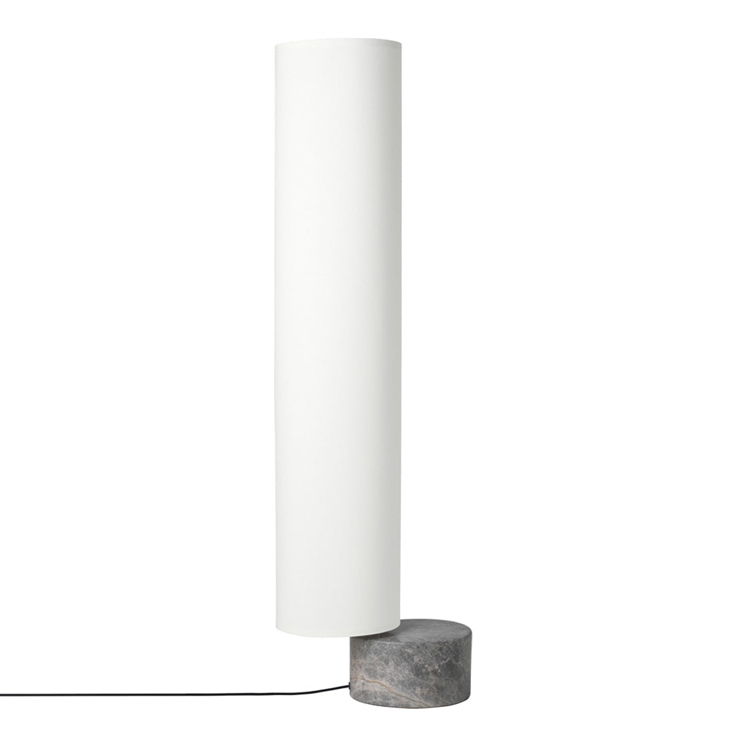 Sleek white cylindrical lamp with a dark speckled marble base, creating a modern and minimalist aesthetic.