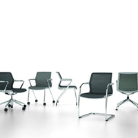 Modern office chairs in various shades of gray with sleek chrome accents and simple geometric patterns.