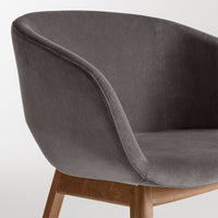 Grey velvet armchair with smooth texture and natural wood legs, featuring a minimalist and modern design.