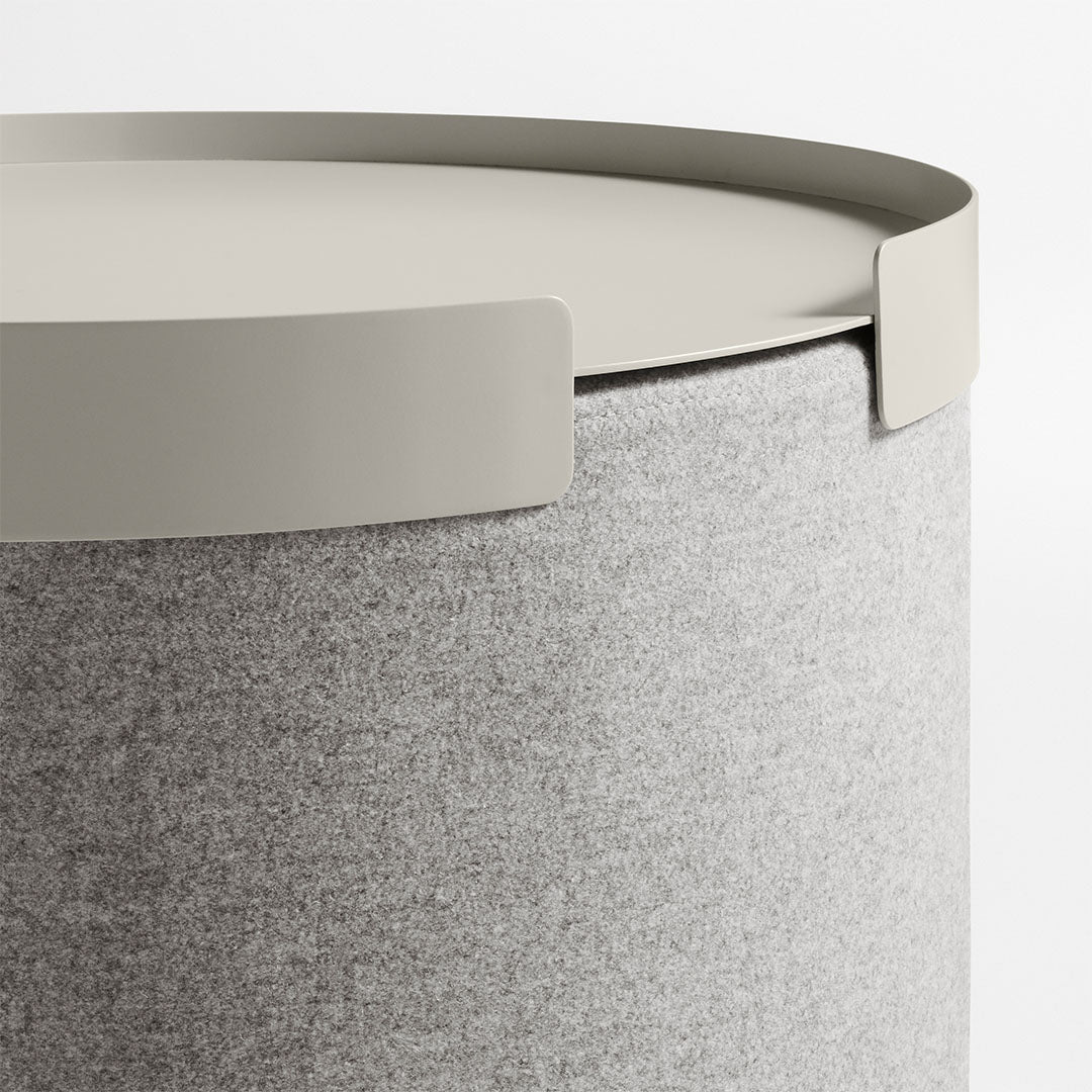 Gray felt storage container with a light gray lid. Smooth texture and minimalistic design. Ideal for modern decor.