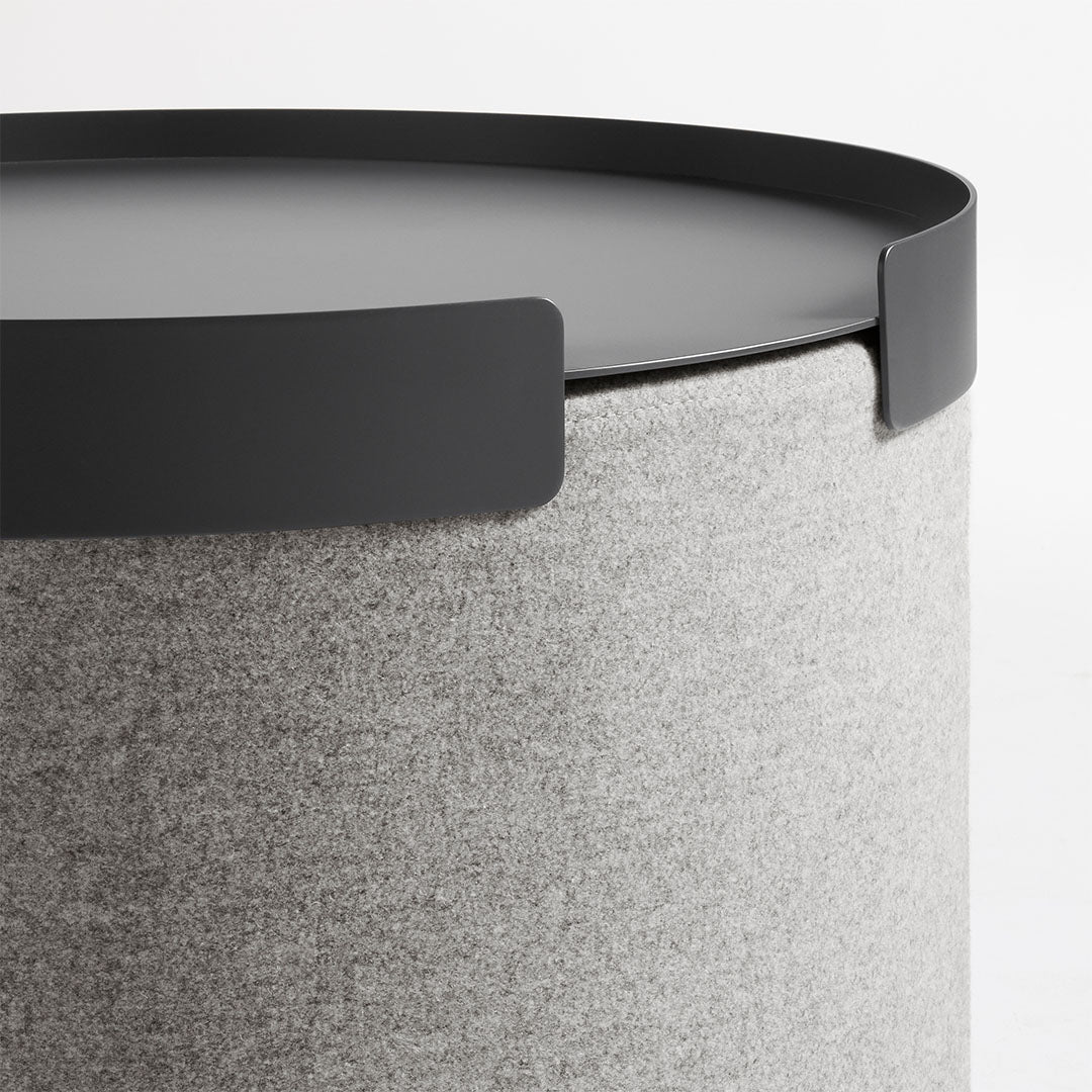 Gray felt storage container with a sleek black lid and minimalist design. Ideal for modern decor.