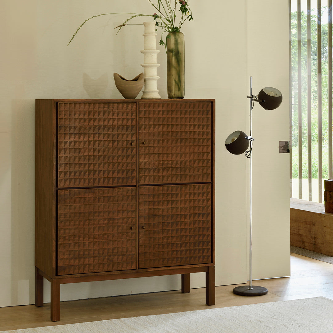 Brown woven wood cabinet with a textured pattern, complemented by a minimalist interior setting.