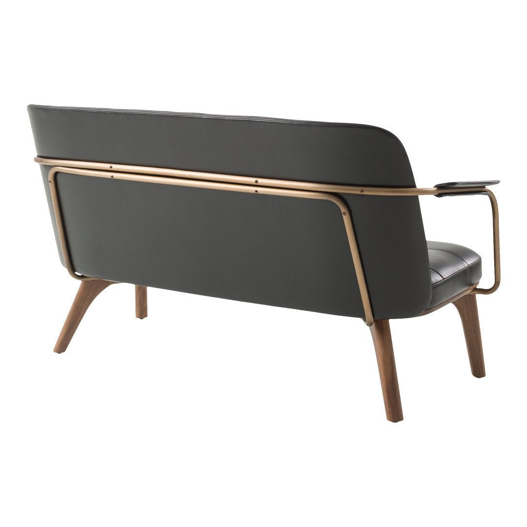 Sleek gray sofa with wooden legs and metallic accents, featuring a smooth, minimalist design.
