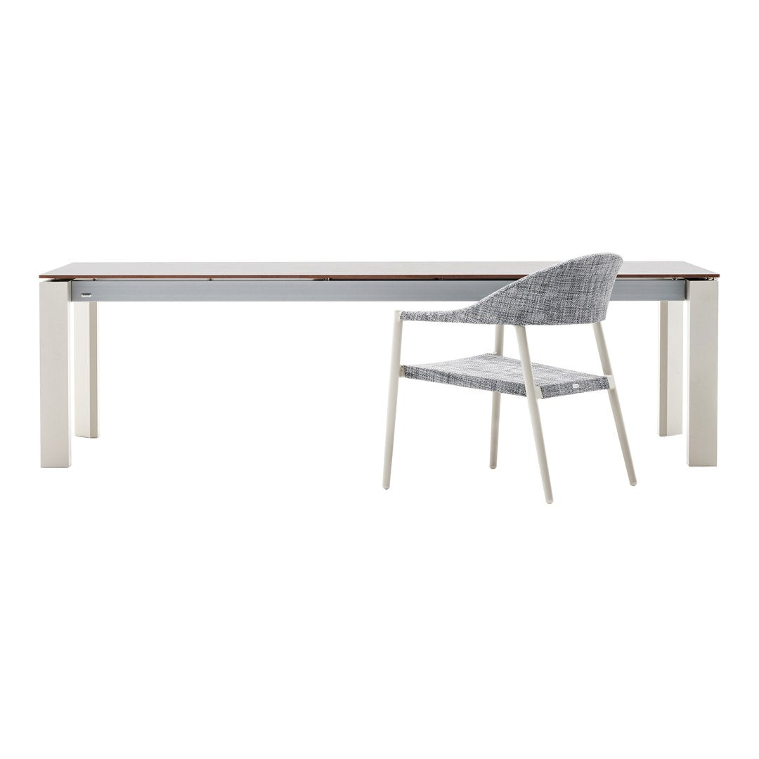 Sleek white and gray dining table with a warm wood top and a textured gray chair, perfect for modern spaces.