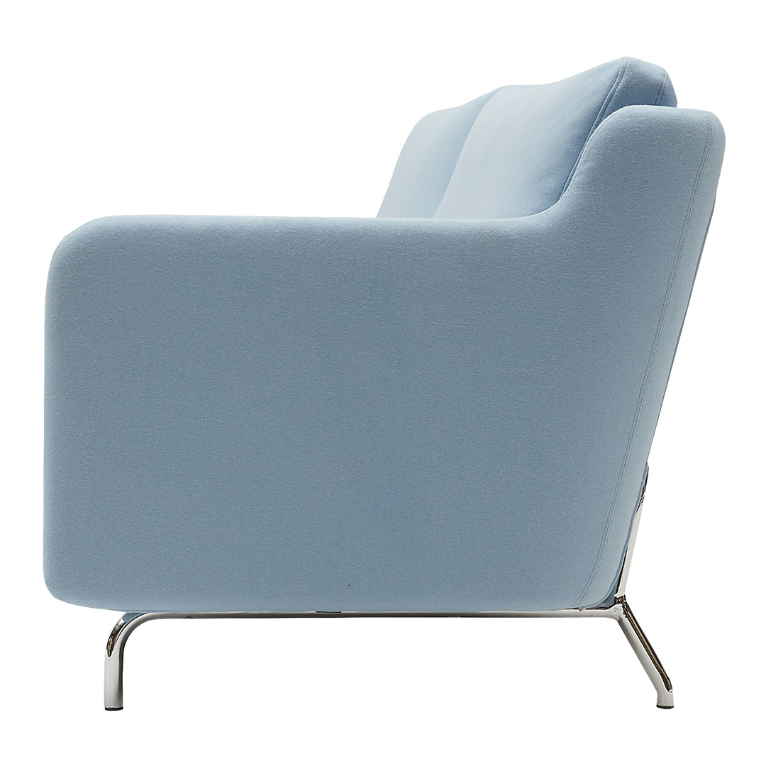 Light blue upholstered sofa with smooth, rounded edges and shiny chrome legs. Perfect for modern living spaces.