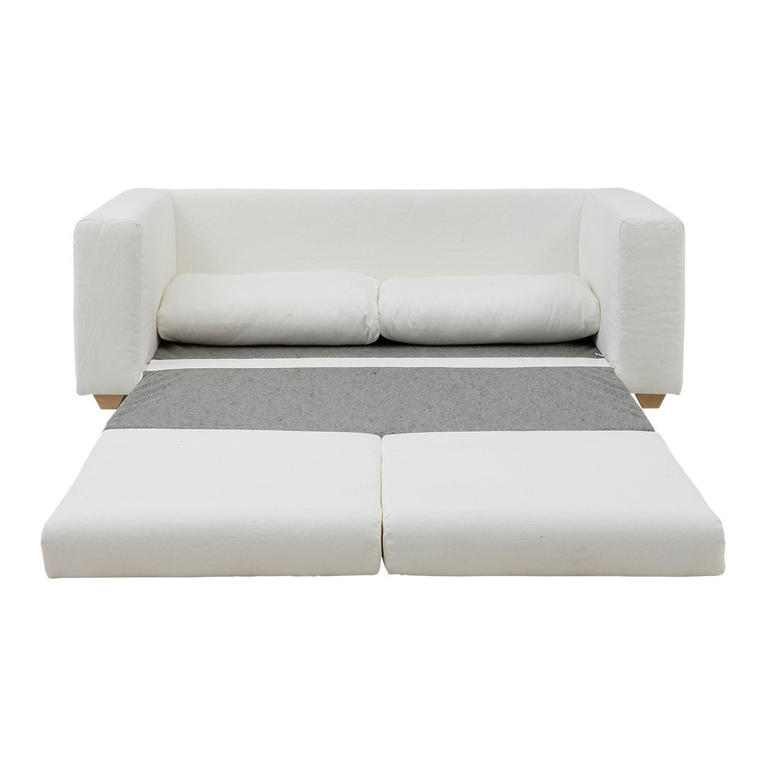 White sofa bed with gray accent cushions and a matching gray fold-out section for versatile styling.