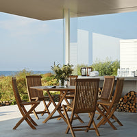Natural wood tones with a sleek design, complemented by a serene coastal backdrop and light reflections.