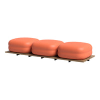 Modern three-piece sofa in vibrant coral color with smooth, rounded cushions on a minimalist wooden base.