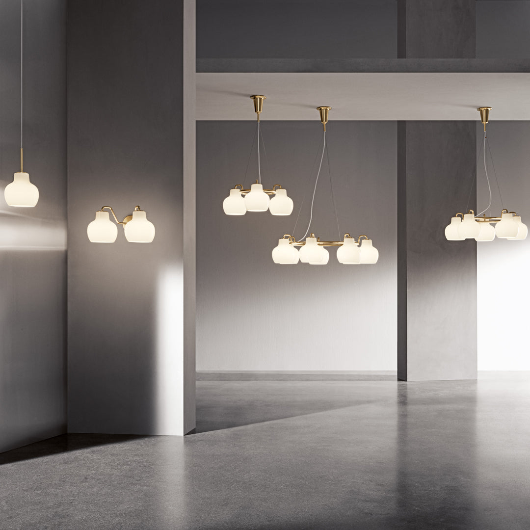 "Modern pendant lights featuring white glass globes with elegant gold accents, in a sleek minimalist setting."