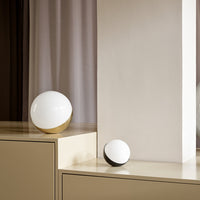 Modern decorative orbs in white and gold, featuring sleek, minimalist design with contrasting matte and glossy finishes.