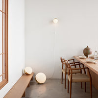 Warm beige wall lighting with soft circular shapes, complemented by wooden furnishings and earthy tones.