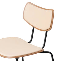 Beige padded chair with a natural wood finish and sleek black metal legs, perfect for modern interiors.