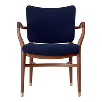 Navy blue upholstered chair with wooden armrests and gold-tipped legs, featuring a sleek, minimalist design.