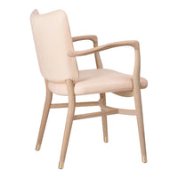 Blush pink upholstered chair with a light wood frame and gold accents, showcasing a sleek, modern design.