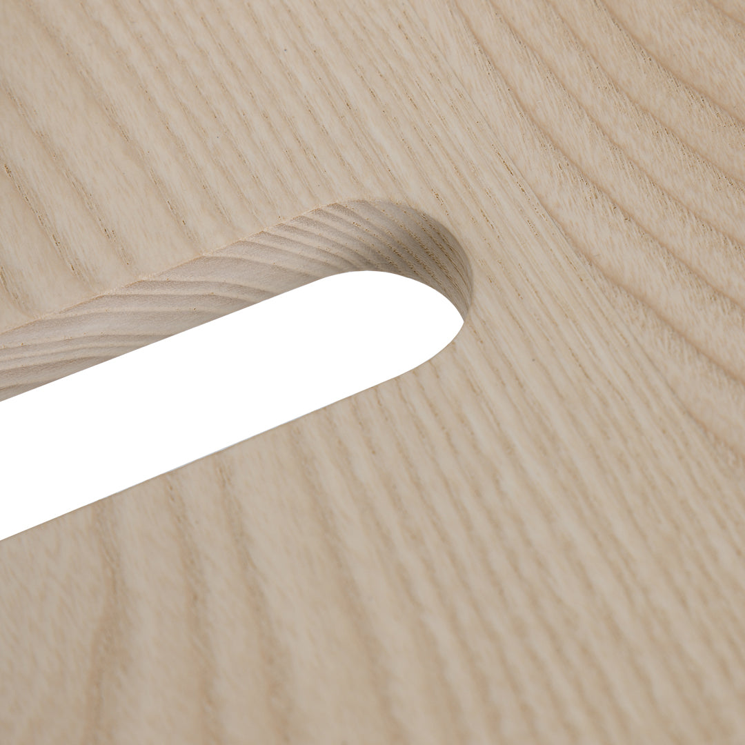 Light oak wood surface with a smooth finish, featuring a subtle grain pattern and a white, rectangular cutout.