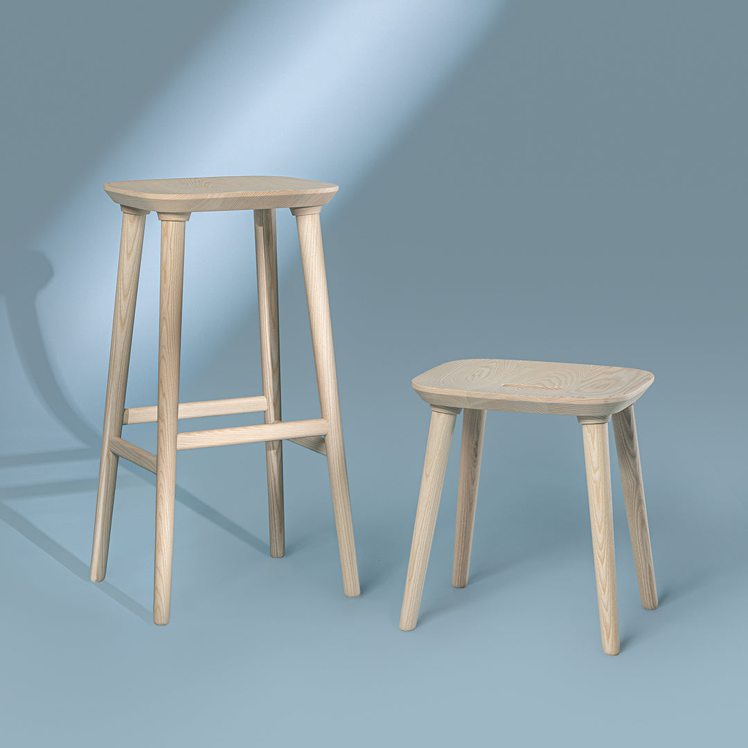 Light wood bar and stool set with smooth, minimalist designs against a soft blue background.