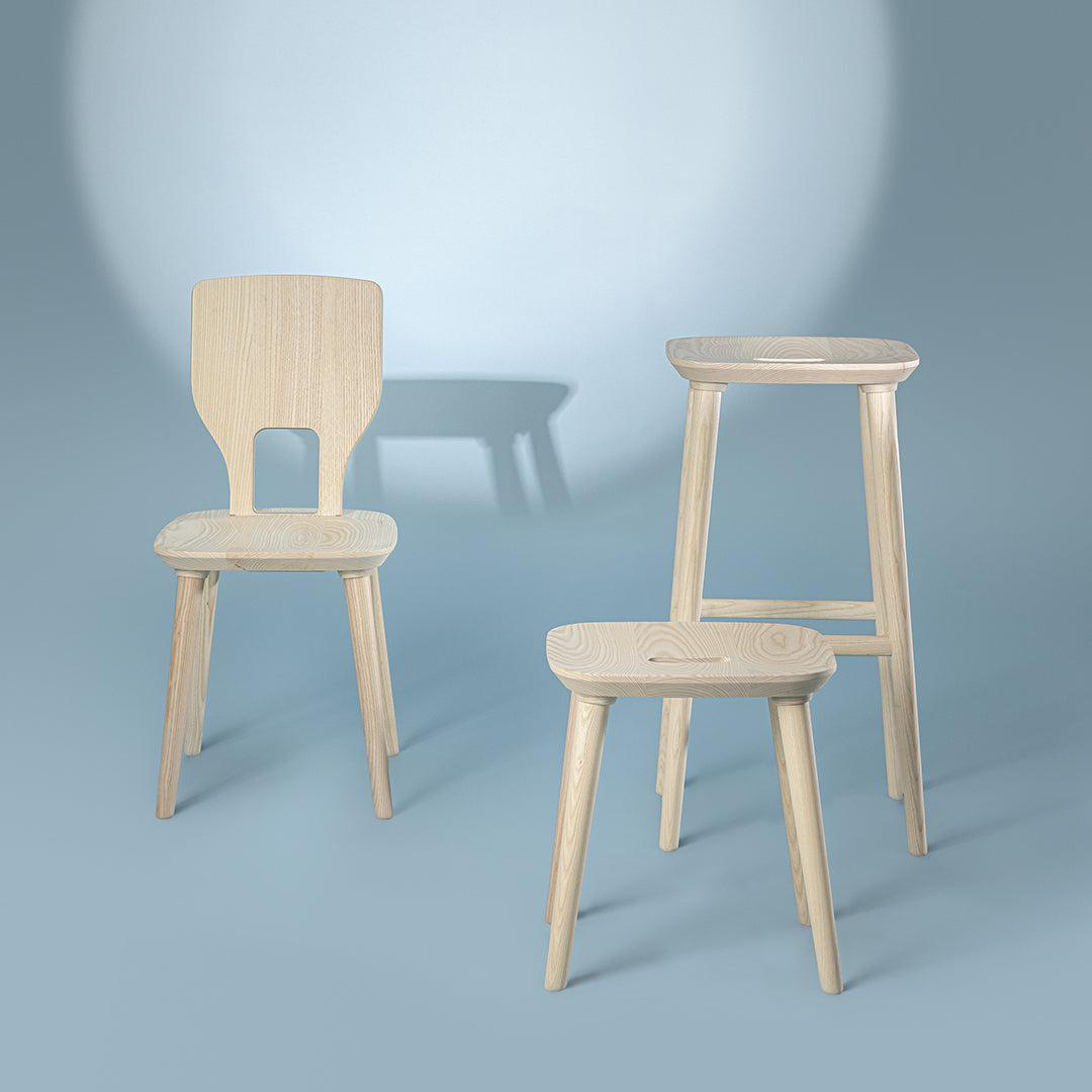 Light wood furniture set with a natural finish, featuring minimalist design and soft, curved shapes against a blue backdrop.