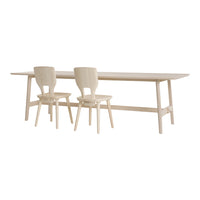 Light-colored wooden dining table with matching chairs, featuring a smooth, minimalist design and natural wood grain.