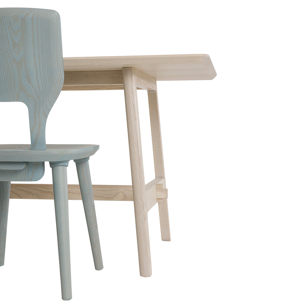 Light blue chair paired with a minimalist wooden table in natural finish, showcasing sleek lines and soft colors.