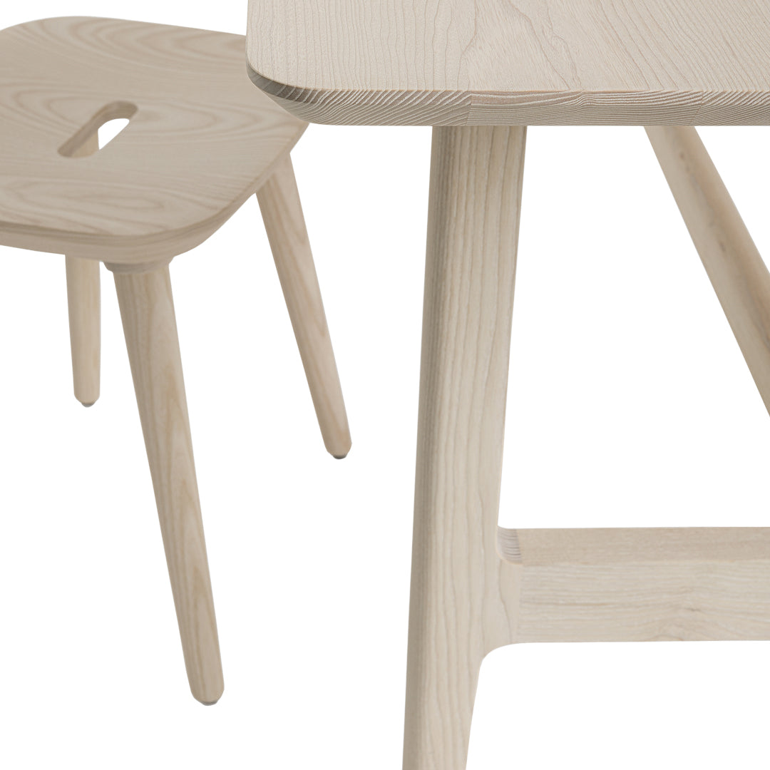 Light wood dining table and stool with smooth textures and natural grain patterns, perfect for minimalist decor.