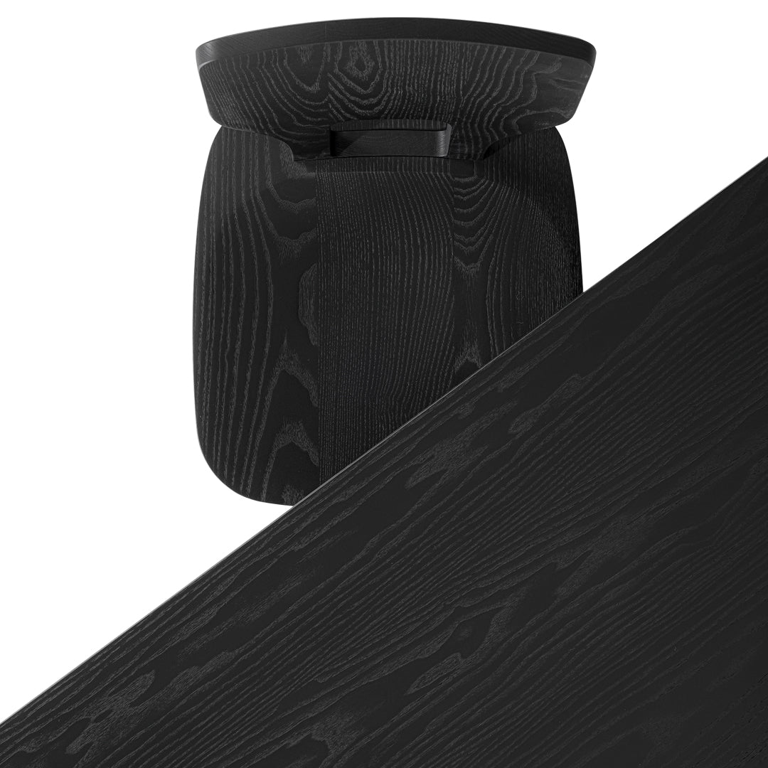 Black wooden table with a sleek, smooth finish and subtle, natural grain pattern.