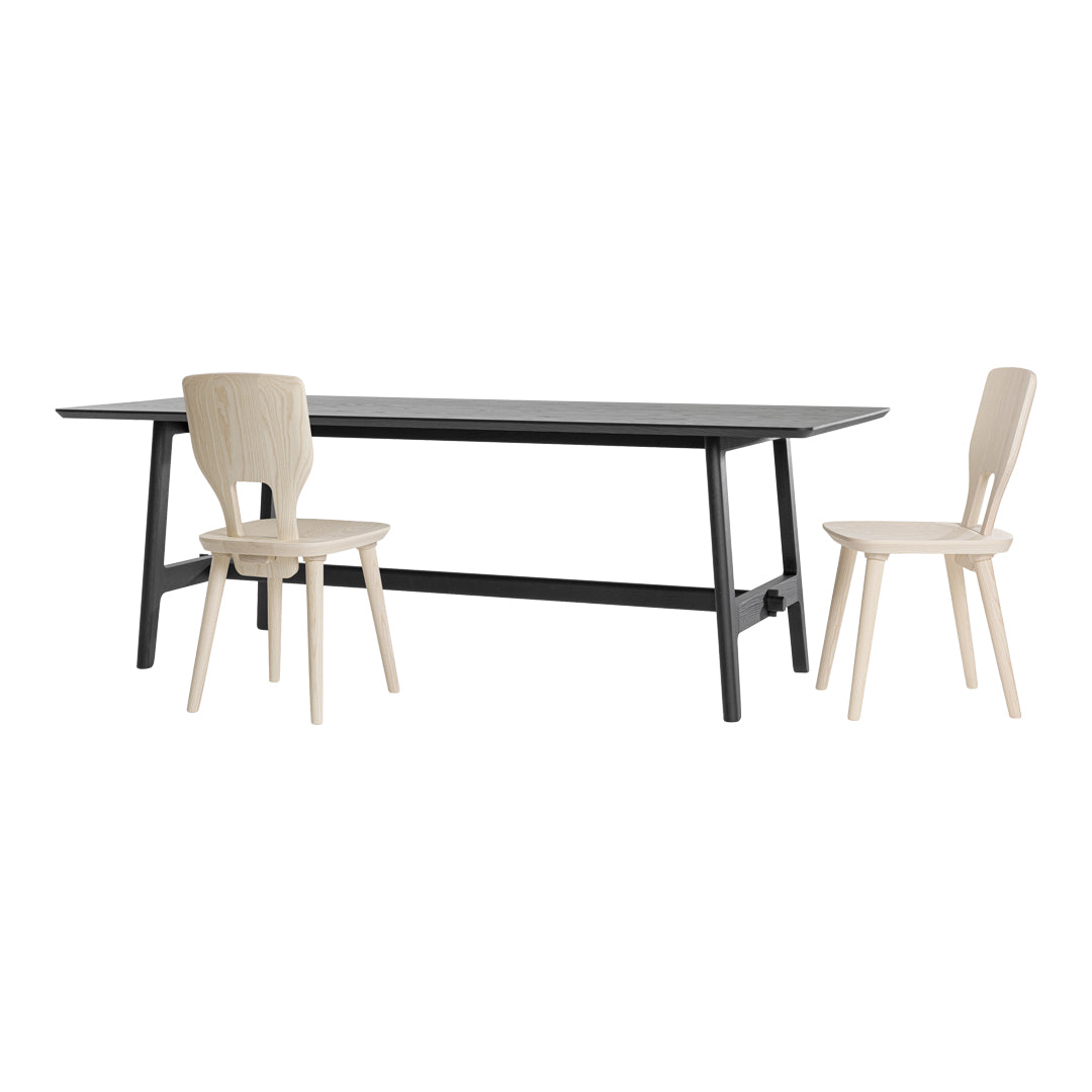 Modern black dining table with minimalist beige wooden chairs, showcasing a sleek and neutral color palette.