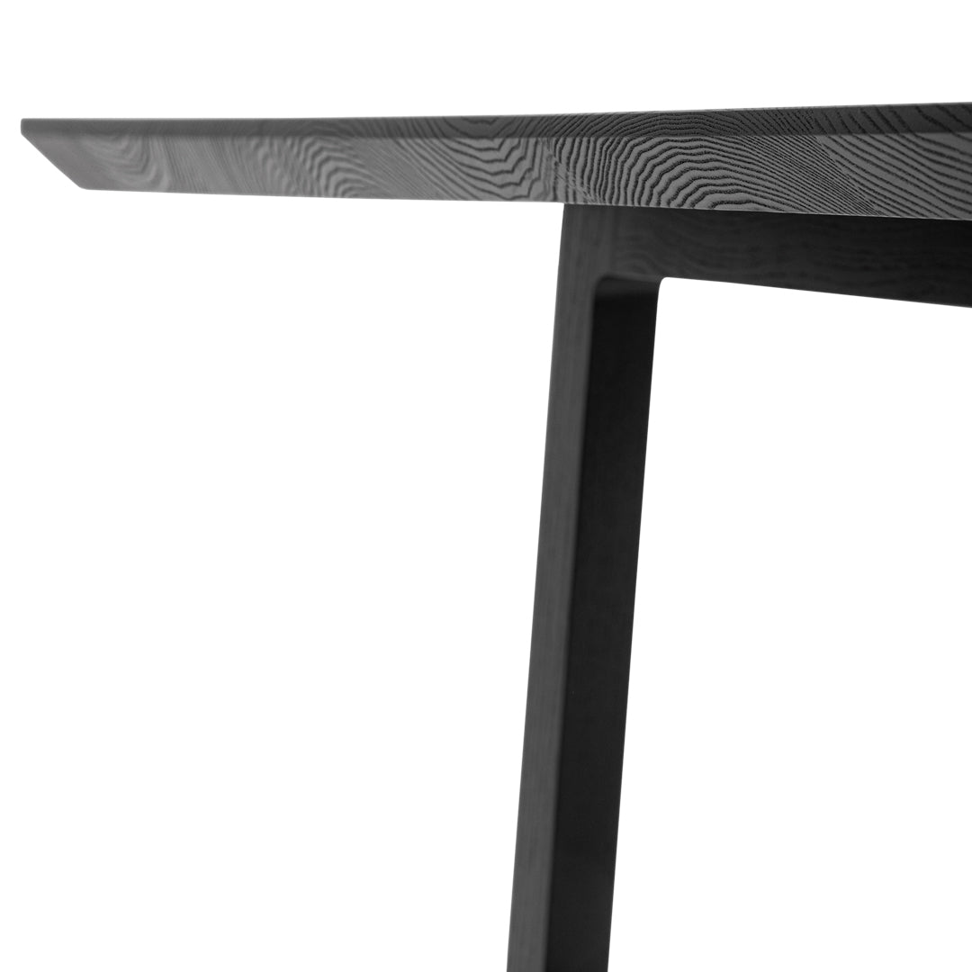 Sleek black table with a smooth finish and subtle wood grain pattern. Modern design for contemporary interiors.