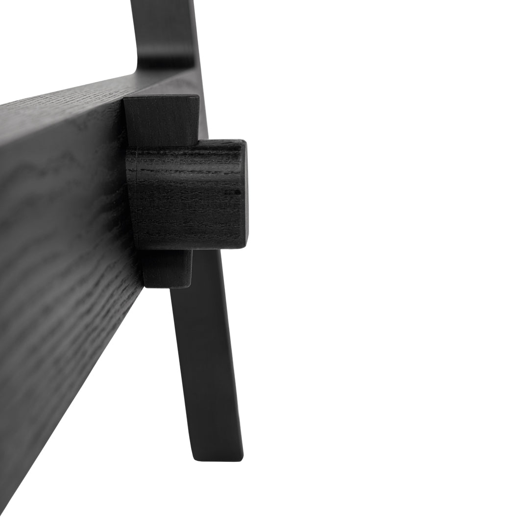 Close-up of sleek black wood finish, showcasing minimalist design and smooth textures.