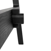 Close-up of sleek black wood finish, showcasing minimalist design and smooth textures.
