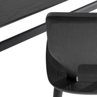 Black wooden chair and table with a smooth, matte finish, showcasing sleek lines and minimalist design.