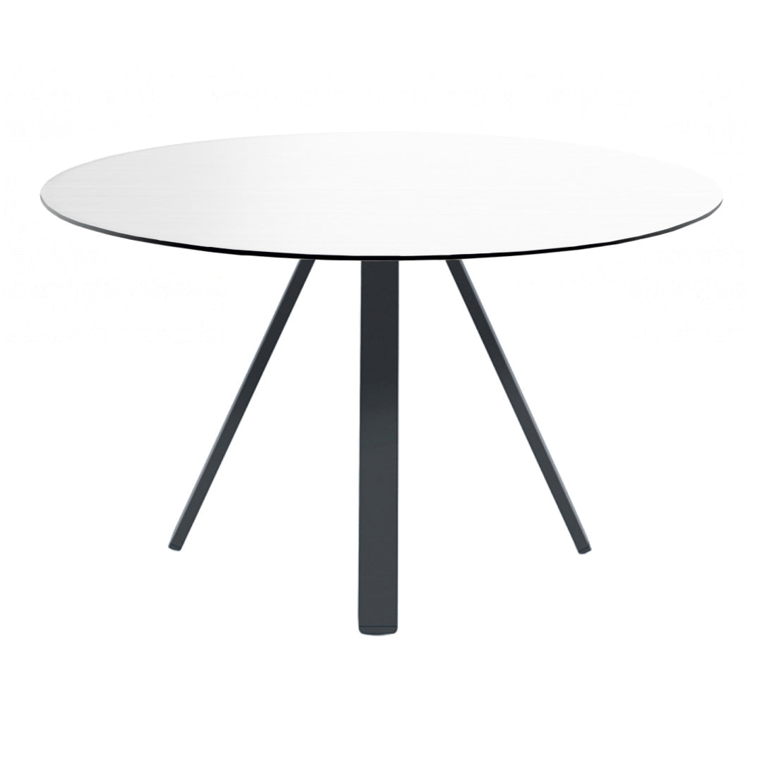 Round white table with sleek black legs, showcasing a minimalist design and modern aesthetic.