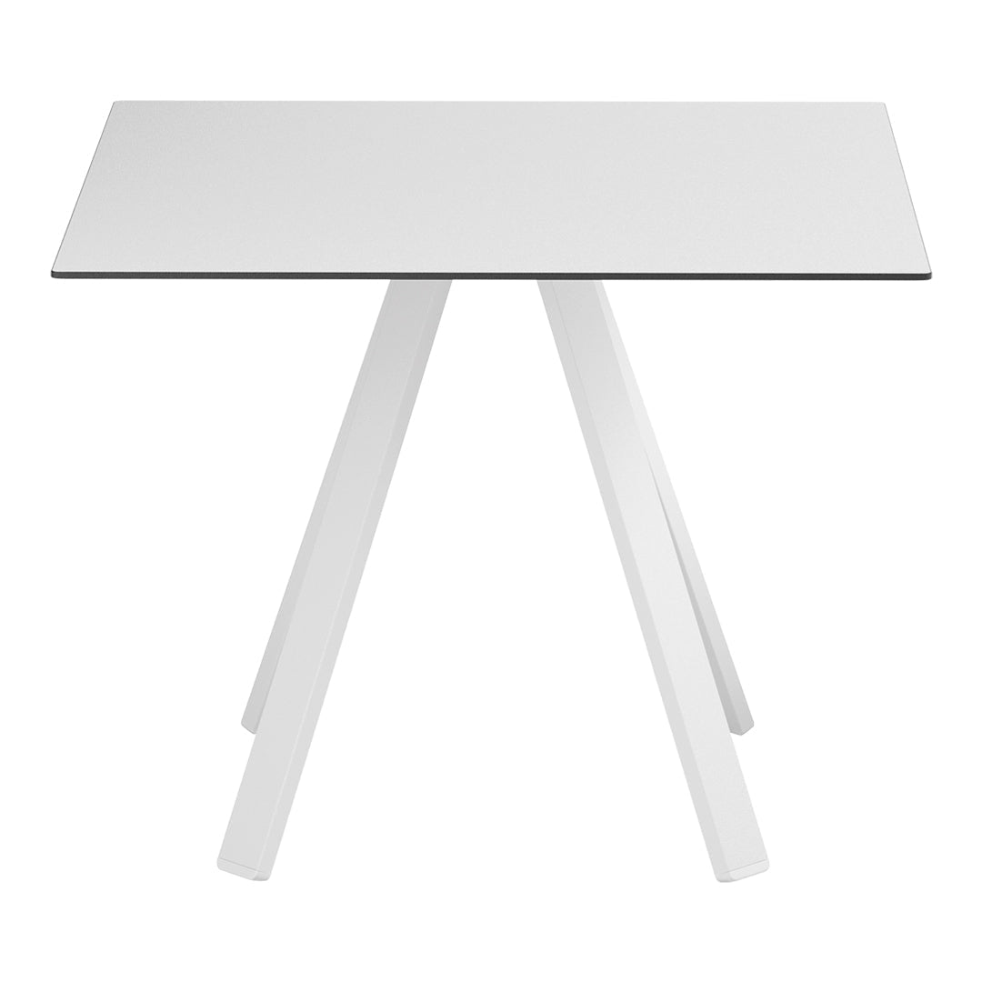 "Modern white table with a sleek design featuring a smooth tabletop and angled legs, perfect for minimalist decor."
